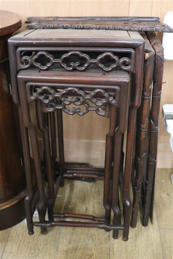 A Chinese nest of three carved hardwood tea tables, each with pierced frieze W.45cm approx.